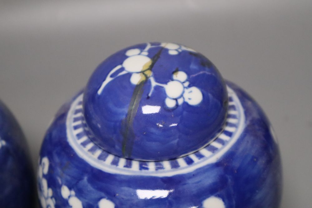 Two Chinese prunus pattern jars, one with a repaired cover, 14cm